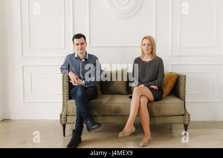 Portrait of Middle Eastern couple sitting on sofa Stock Photo