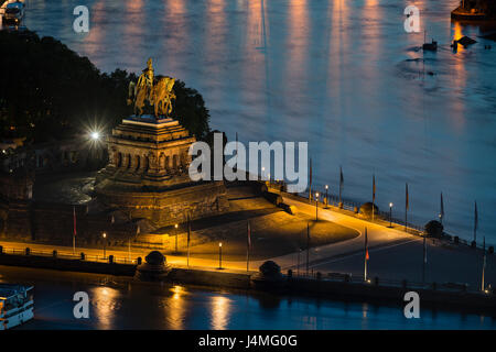 View of Deutsches Eck with the statue of the emperor William I in Koblenz, Germany with  Rhine and Moselle River in the night. Stock Photo