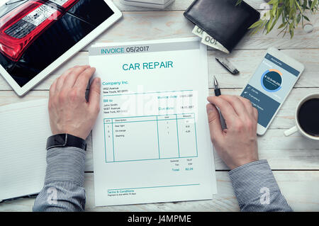 Car repair invoice on the table. Stock Photo