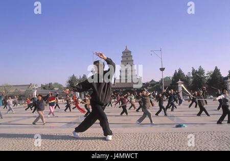 China, province of Shaanxi, Xian, big wild goose's pagoda, forecourt, people, Tai Chi Asien, Eastern Asia, town, tower, structure, building, wild goose's pagoda, Buddhist, 7-storied, 64 m high, Buddhism, religion, faith, art, culture, place of interest, shadow boxer, leisure time, hobby, Tai Ji, Tai-Chi, meditation, motion practise, détente, practise, coordination, harmonisation, motion meditation, meditation technology, fight art, meditative, shadow speakers Stock Photo