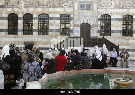 Syria, Damascus, Old Town, Souq, palace, well, women, Azem Palace, inner courtyard, building, facade, window, bars, stairs, water cymbal, fountain, person, locals, clothes, headscarfs, Weihrauchstrasse Stock Photo