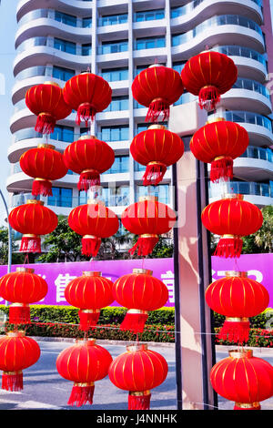 Hainan island in Shenzhou Peninsula, China - February 16, 2017: Street view at sunset with many Chinese red lanterns Stock Photo