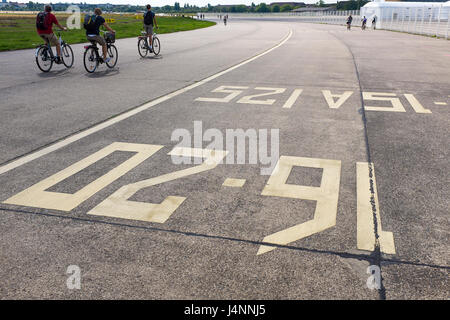 Berlin's once iconic Tempelhof Airport is put to good use. The terminal as a n asylum seekers refuge, the runways as a park. Berlin, Germany Stock Photo