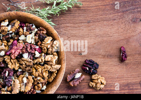 Walnuts in a a bowl on wooden background Stock Photo