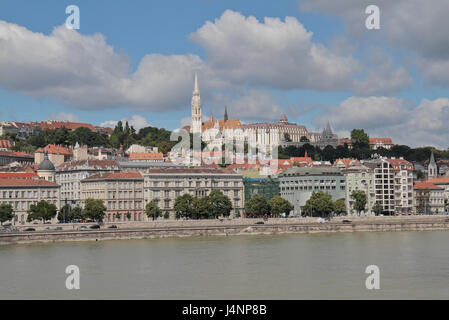 The spire of Matthias Church (Mátyás Templom) and the Castle District (Budai várnegyed) viewed over the River Danube in Budapest, Hungary. Stock Photo