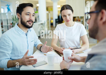 Interview of two employers with one of applicants for vacancy Stock Photo