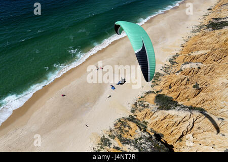 A paraglider flying over Aberta Nova beach. Stock Photo