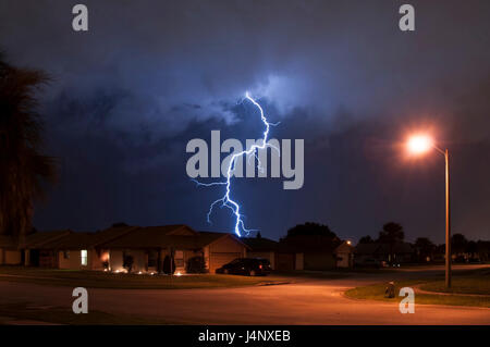 Massive lightning strike very close to homes in a neighborhood Stock Photo