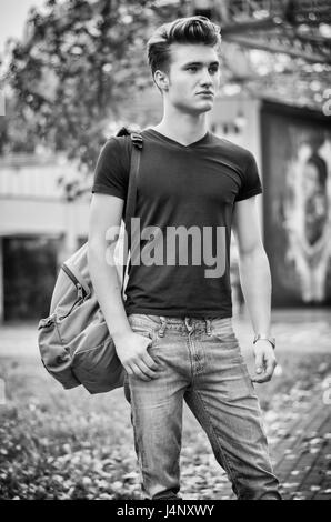 Young man standing in city environment, with backsack Stock Photo