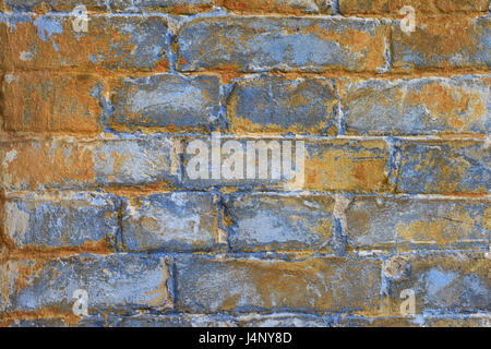 Fragment of old brickwork: bricks blue tint with rusty rust color, texture of ancient stone faded wall. Stock Photo