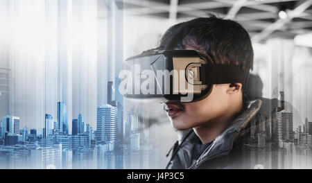 Businessman wearing virtual reality googles, with double exposure modern buildings technology Stock Photo
