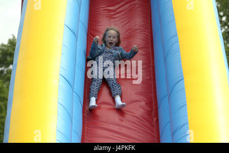 Savannah Phillips, daughter of Peter and Autumn Phillips, goes on a slide during the Royal Windsor Horse Show, which is held in the grounds of Windsor Castle in Berkshire. Stock Photo