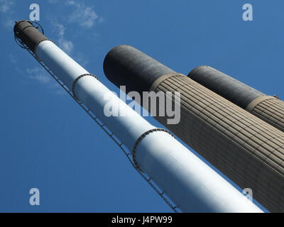 tall industrial chimneys in concrete and steel with blue sky Stock Photo