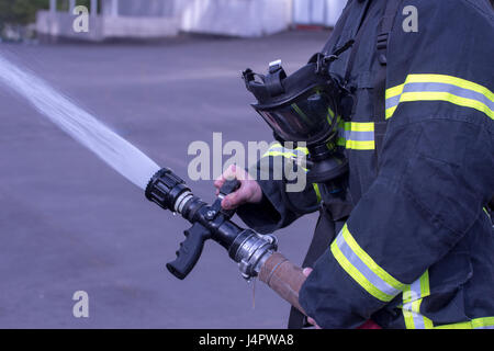 Water extingisher in hands, close up view. Stock Photo