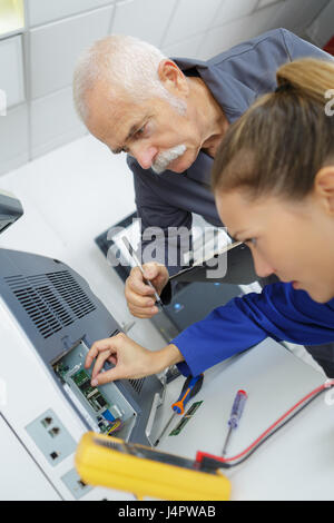 Technicians repairing electrical appliance Stock Photo