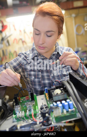 Female technician using probe in electrical system Stock Photo