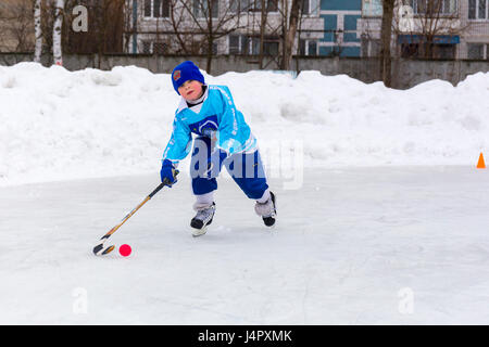RUSSIA, KOROLEV- FEBRUARY 18, 2017: Young hockey player have a warm up training before the match on bandy tournament in Korolev, Russia Stock Photo
