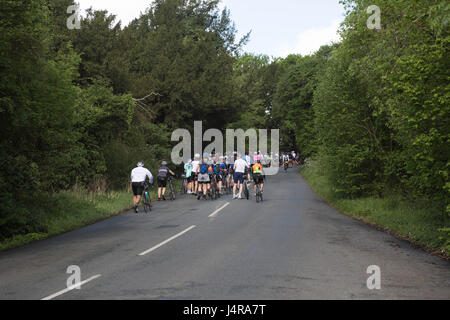 West Wycombe, Bucks, UK. 14 May 2017. bicycle rider suffers from heart attack on cycle rid  cycles queuing on the hill on the London Revolution cycle challenge Credit: Brian Southam/Alamy Live News Stock Photo