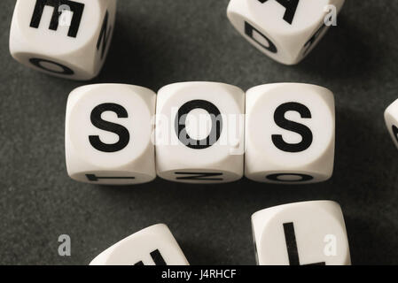 word sos on white toy cubes Stock Photo