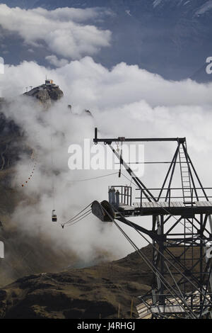 Top terminal Schilthorn, cable car, gondola, one, floating, view in the valley, morning tuning, clouds, early fog, Switzerland, canton Bern, Lauterbrunnertal, Stock Photo