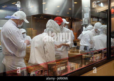 Chines chefs prepare food in restaurant in Shopping Mall in Shanghai, China, February 28, 2016. Stock Photo