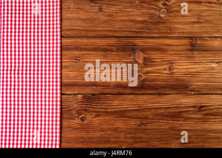 Red checkered tablecloth on old wooden background. Top view, text space Stock Photo