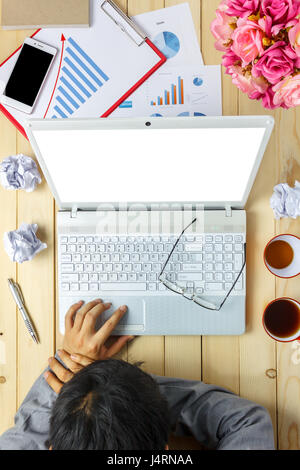 Top view business person sleeping on charts and graphs during discussing  also laptop,notebook,black coffee,stationary,pen,mobile phone on office desk Stock Photo