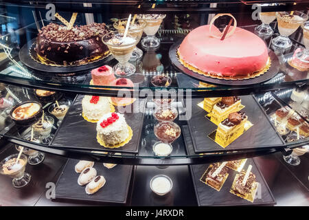 Different desserts on bakery shop-window. Sweets and cakes for every taste Stock Photo