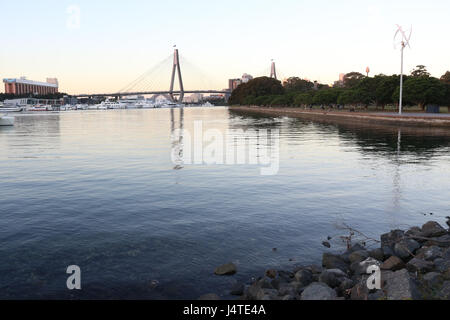 View from Bicentennial Park, Annandale across Rozelle Bay with the ANZAC Bridge and Sydney Harbour Bridge visible in the distance. Stock Photo