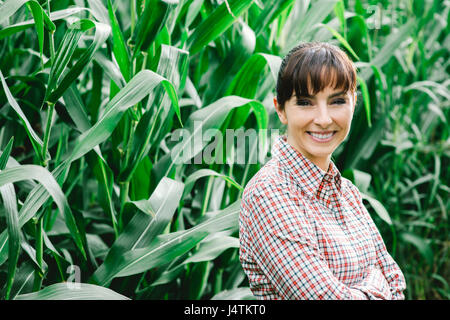 Happy farmer posing in the corn field Stock Photo - Alamy