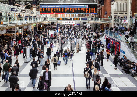 Commuters wait for their trains to take them home at Liverpool Street Mainline Station in Central London
