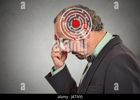 Right decision wisdom strategy concept. Side profile middle aged man solving problem isolated on gray wall background. Face expression Stock Photo