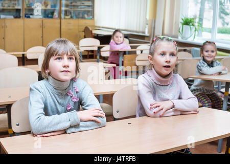Children in school listen to the teacher Stock Photo