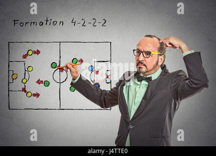 strategy. Middle aged businessman leader thinking planning on next business plan proposition move isolated grey wall blackboard background. Face expre Stock Photo