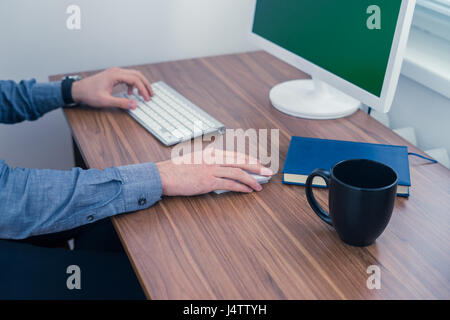 Hands of office man working at computer desk Stock Photo