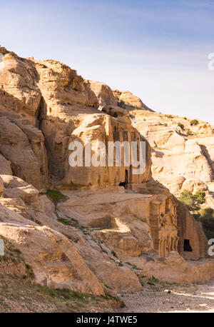 The carved Doric column facade of the Obelisk Tomb, Bab as-Siq, Petra Jordan with the Triclinium beneath it. Photographed at a distance from the side. Stock Photo
