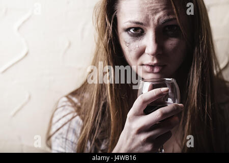 Young crying woman with a glass of wine Stock Photo