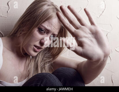 Young woman victim of domestic violence and abuse Stock Photo