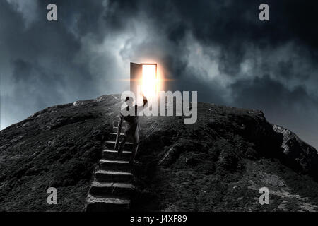 Young businessman walking up stone staircase as symbol for achievement. Mixed media Stock Photo