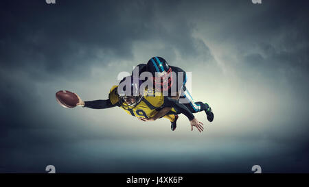 Two american football players fighting for ball Stock Photo