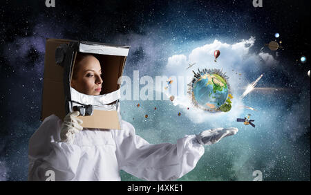 Woman wearing astronaut suit and helmet. Mixed media. Elements of this image are furnished by NASA Stock Photo