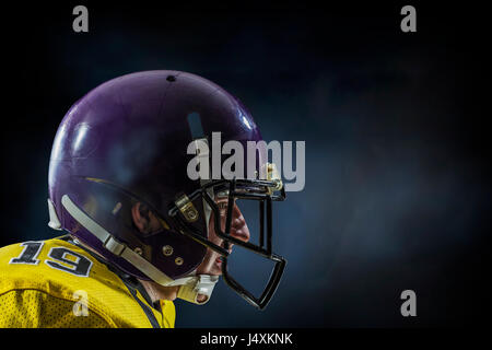 American football player on dark sky background Stock Photo
