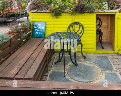 A recycled pallet display in a garden centre with furniture made from discarded wooden pallets Stock Photo