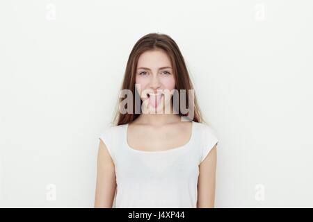 Pretty funny young girl showing tongue Stock Photo