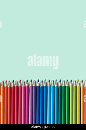 Set Of Children's Colouring Pencils On A Green Background Wth Copy Space Stock Photo