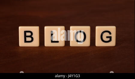 Personal Blog Headline. Social networking concept. Ivory tiles with capital letters on mahogany board. Stock Photo