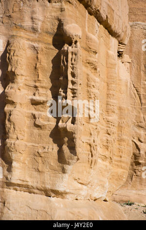 Close up of carving on stone Djinn Block marking the entrance of a tomb in Petra Jordan, the ancient Nabataean city of Raqmu. Stock Photo