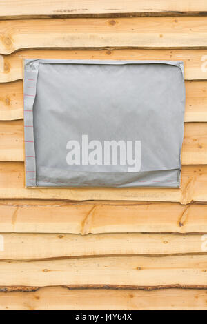Wooden shingle wall (actually an outside office) with blanked out space for windows. Stock Photo
