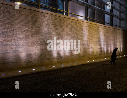 Rome, Italy - 29 March 2014 - Man walking alone in the street in the evening looking sad and resigned Stock Photo