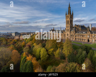 Aerial photo of the Gilbert Scott tower Glasgow University taken during a drone flight during an autumnal sunset above Kelvin grove park in Glasgow Stock Photo
